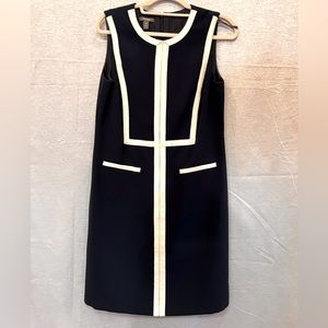 Navy blue, tailored, knee length dress. Zipper back. No stretch. Fully lined.